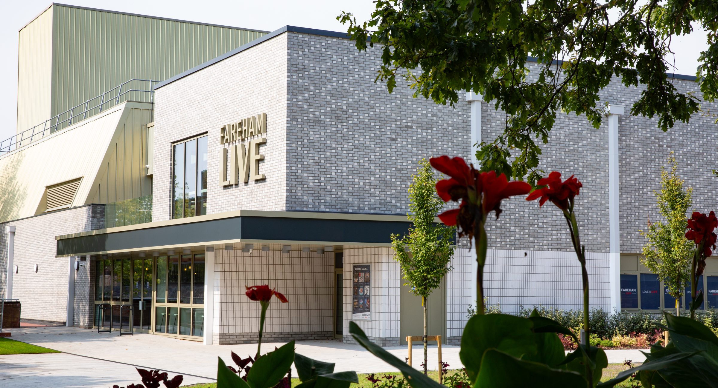The exterior of Fareham Live with trees and florals in the foreground.