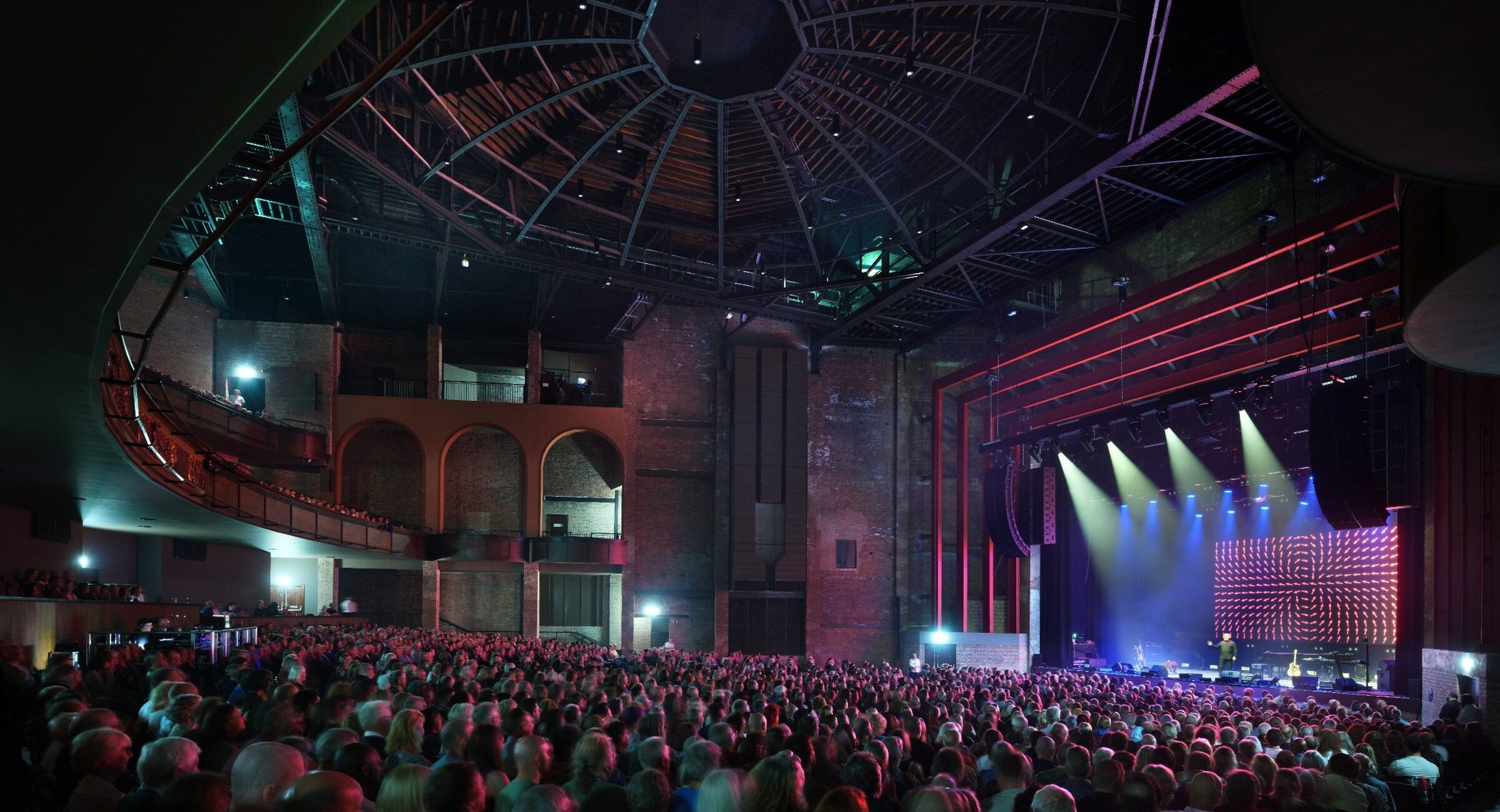 Inside the auditorium, with a full audience watching a contemporary performance